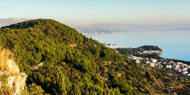 View from hill in city of Split. Split is famous because this town have a park forrest just few hundred meters from center of city. / Coastline of city Split from hill, Croatia.